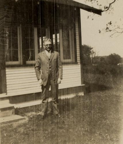 Arthur Trout Sr standing in front of their cabin in Tower Lakes, IL